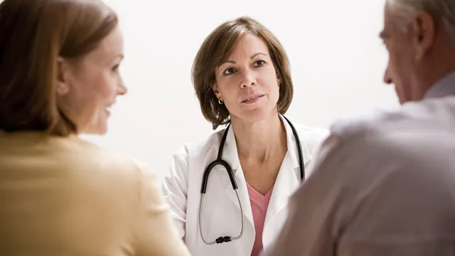 Oncologist reviewing a Protocol Report with a patient and family member